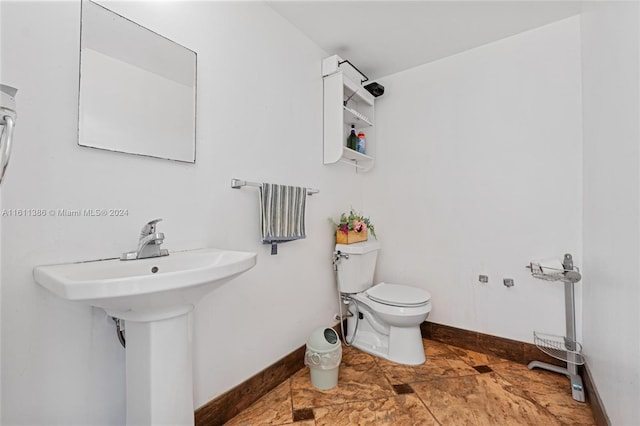 bathroom featuring toilet and tile floors