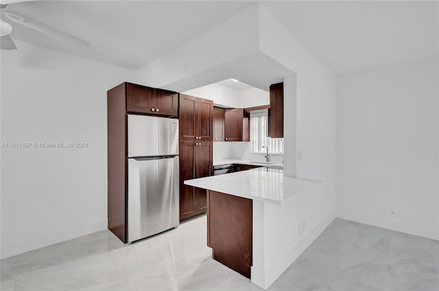 kitchen with sink, ceiling fan, appliances with stainless steel finishes, dark brown cabinets, and kitchen peninsula