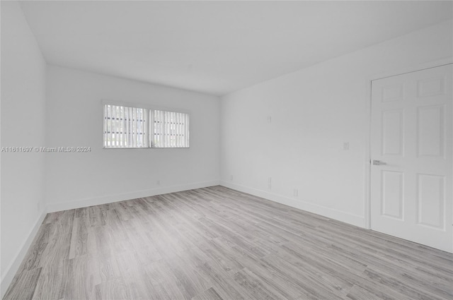 spare room featuring light hardwood / wood-style flooring