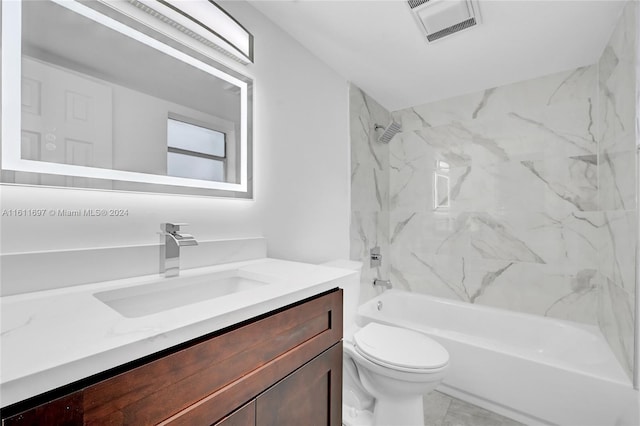 full bathroom with vanity, toilet, and tiled shower / bath