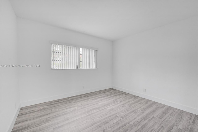 spare room with light hardwood / wood-style flooring