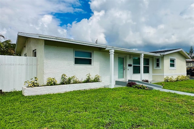 ranch-style house with a front lawn