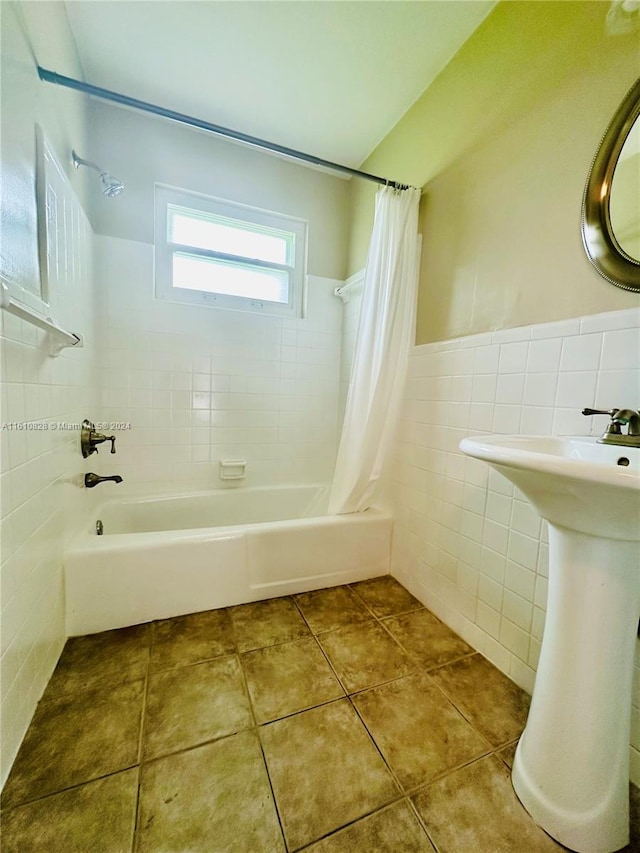 bathroom featuring tile walls, shower / bath combo, and tile patterned flooring