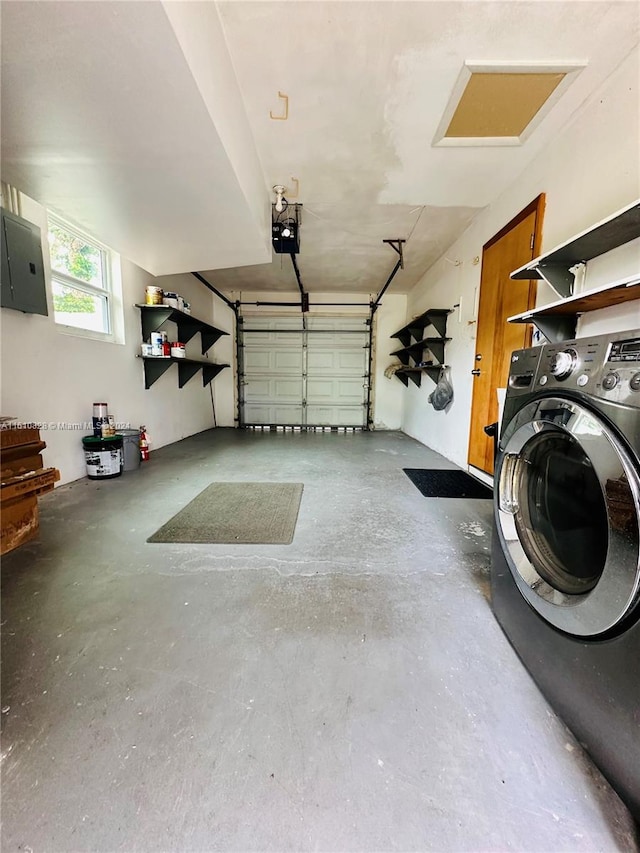 garage featuring washer / dryer, a garage door opener, and electric panel