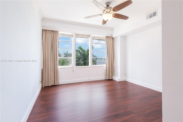 empty room with dark hardwood / wood-style flooring and ceiling fan