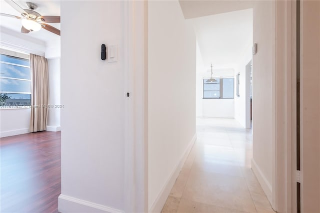 corridor with light hardwood / wood-style floors