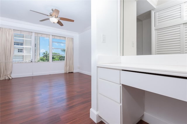 interior space featuring ornamental molding, ceiling fan, and dark hardwood / wood-style floors