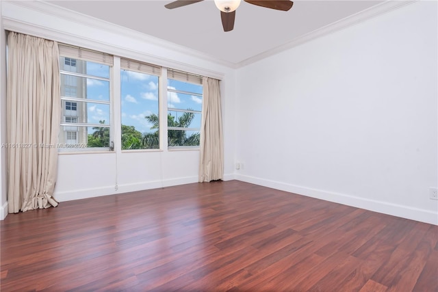 unfurnished room featuring dark wood-type flooring, ceiling fan, and crown molding