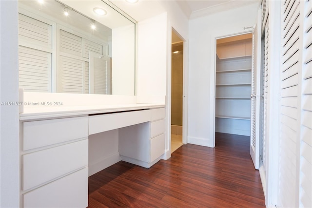 interior space featuring dark wood-type flooring and crown molding