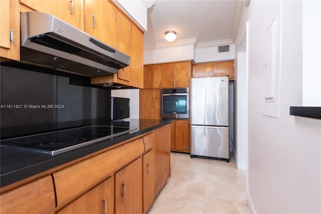 kitchen with crown molding, exhaust hood, and stainless steel appliances