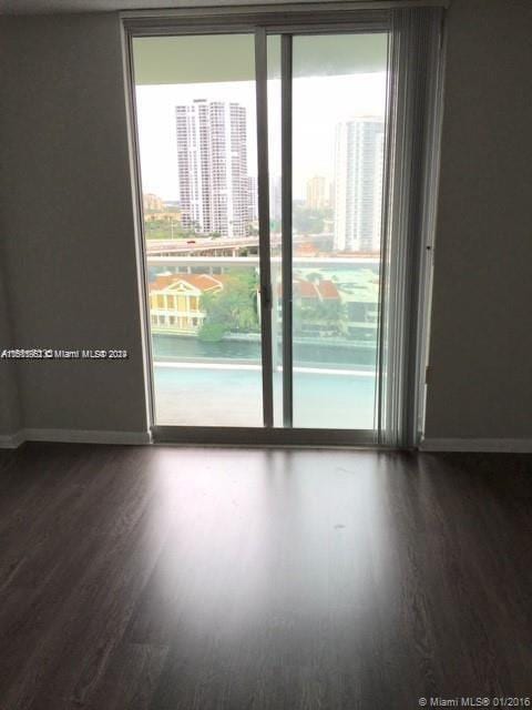 empty room featuring hardwood / wood-style flooring and plenty of natural light