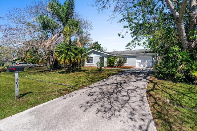 ranch-style house with a garage and a front yard