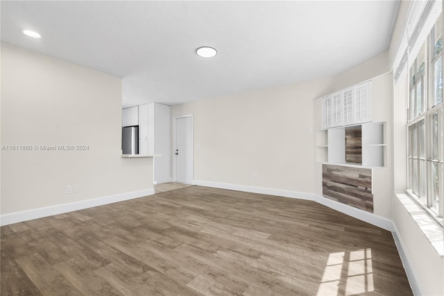 unfurnished living room featuring wood-type flooring