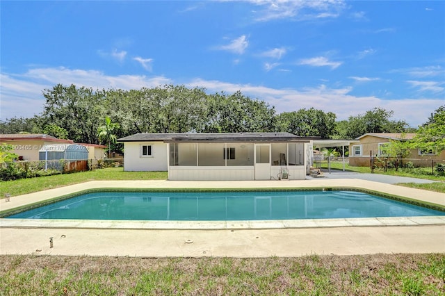 view of swimming pool with a sunroom