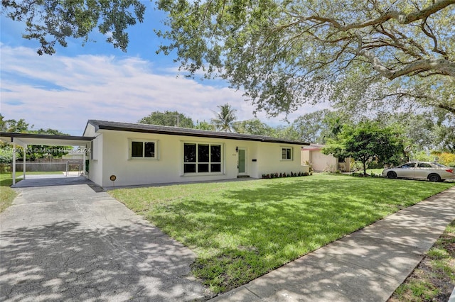 ranch-style house featuring a carport and a front lawn