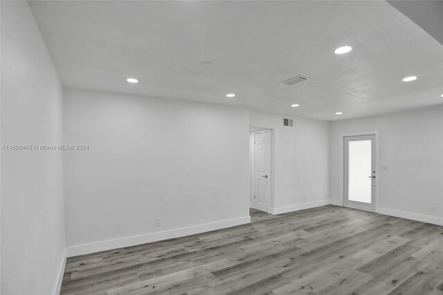 unfurnished room with wood-type flooring