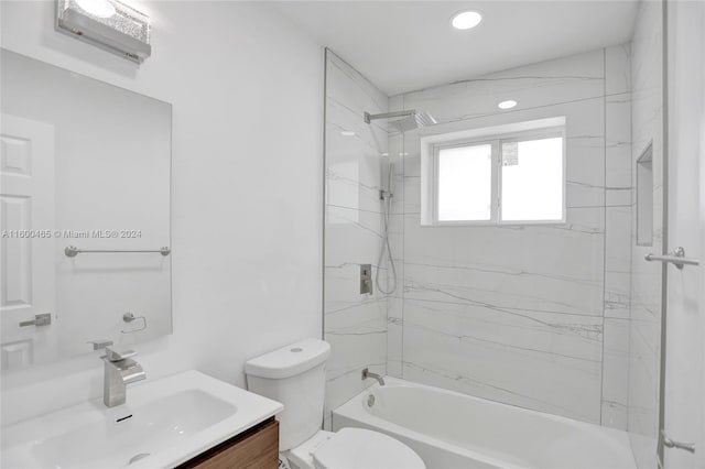 full bathroom with vanity, toilet, and tiled shower / bath