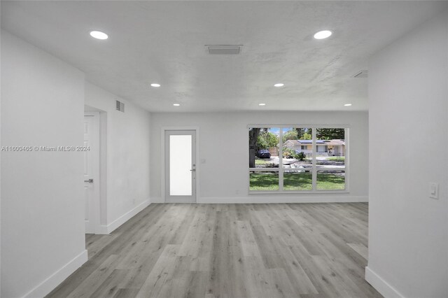 unfurnished living room featuring light wood-type flooring