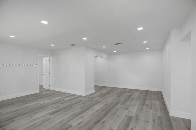 spare room featuring wood-type flooring