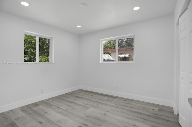 unfurnished room featuring light hardwood / wood-style flooring and a healthy amount of sunlight