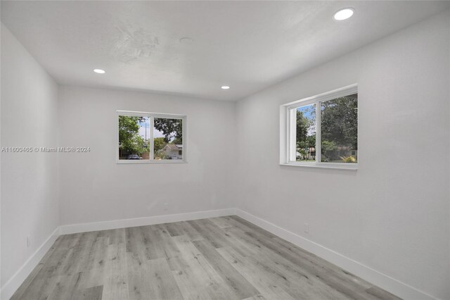 unfurnished room featuring plenty of natural light and light hardwood / wood-style floors