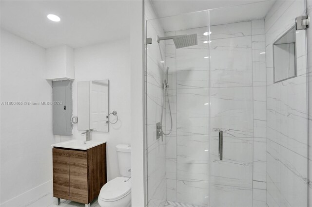 bathroom with toilet, vanity, and an enclosed shower