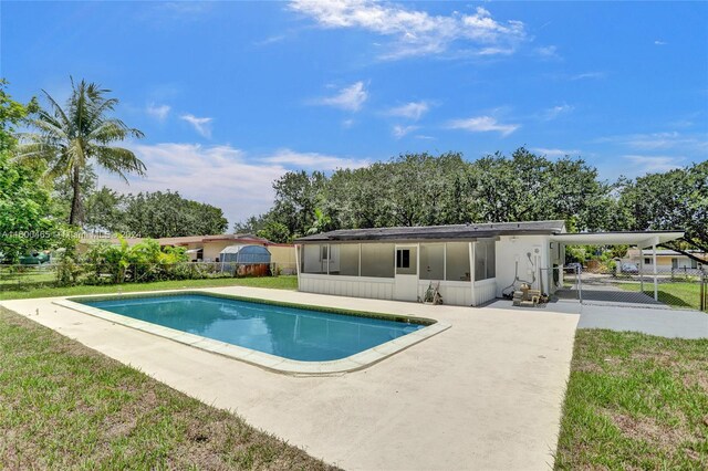 view of pool with a yard