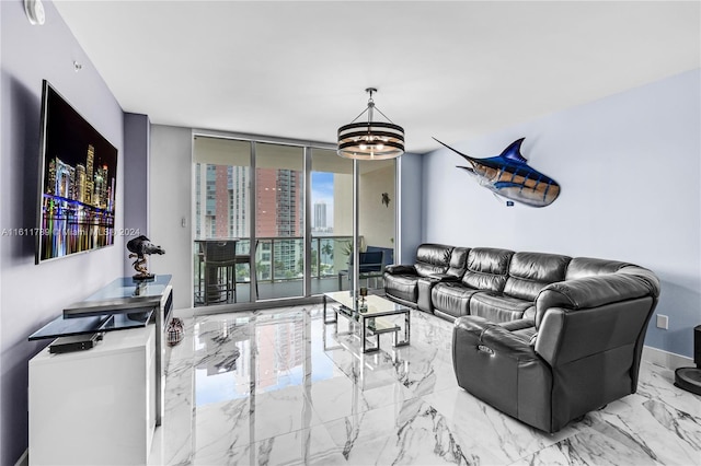 tiled living room featuring a notable chandelier and floor to ceiling windows