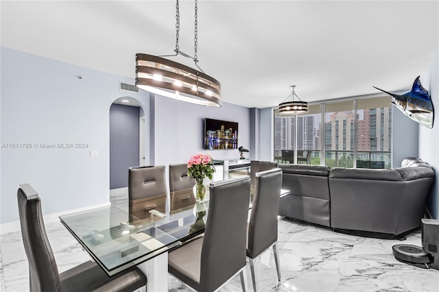 dining area featuring light tile floors