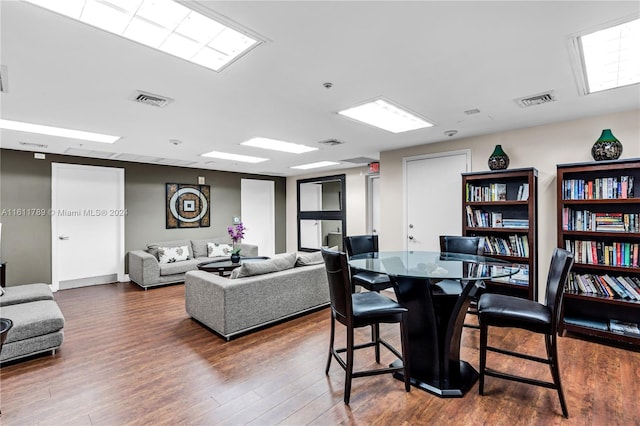 dining space with wood-type flooring