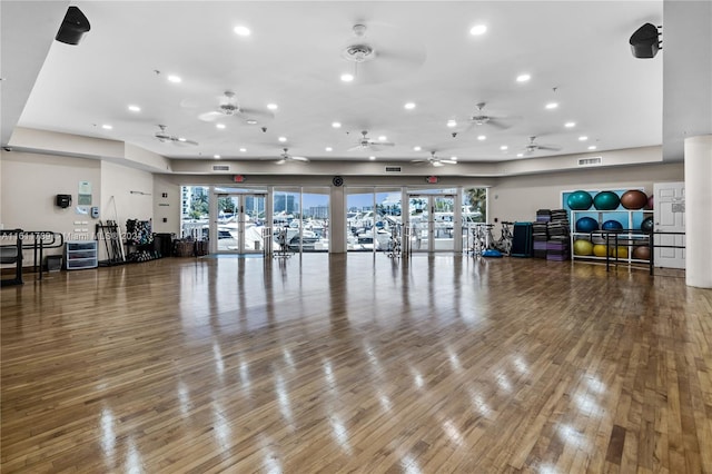 exercise room with ceiling fan, french doors, and wood-type flooring