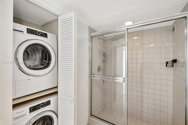 clothes washing area with stacked washer and dryer