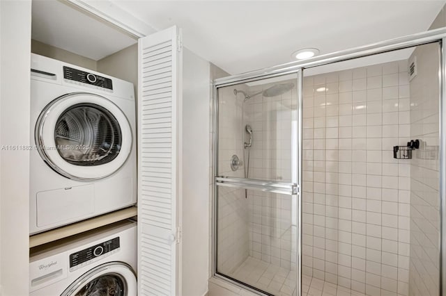 washroom featuring laundry area and stacked washer / drying machine