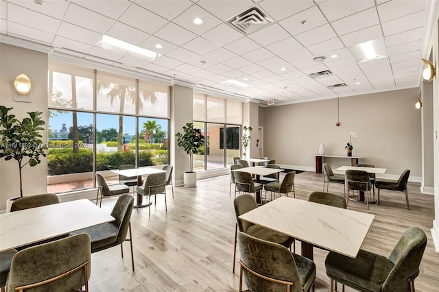 dining room featuring baseboards, visible vents, and light wood-type flooring