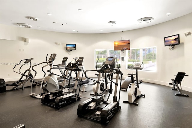 exercise room with visible vents and baseboards