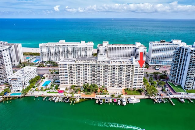 drone / aerial view featuring a view of city and a water view