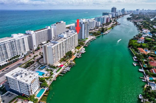 birds eye view of property featuring a city view and a water view