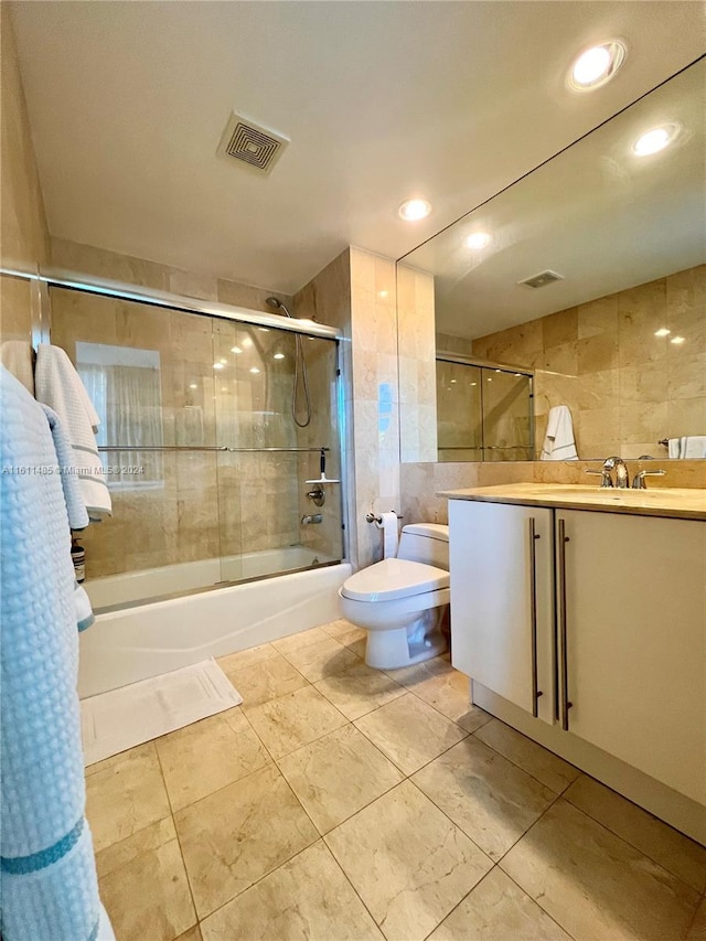 full bathroom featuring vanity, toilet, shower / bath combination with curtain, and tile walls