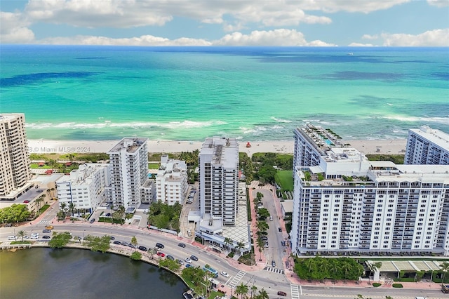 aerial view featuring a water view and a beach view