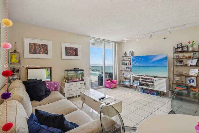 living room featuring a textured ceiling and light tile patterned floors