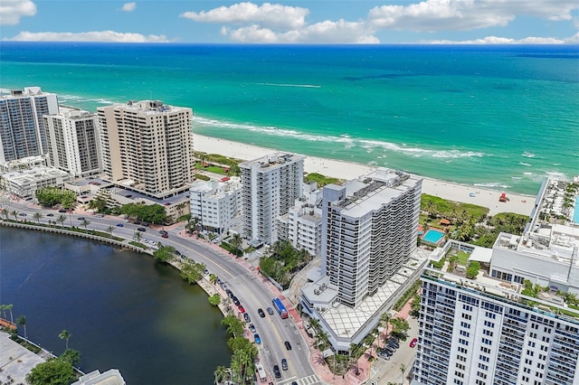 drone / aerial view with a water view and a beach view