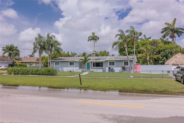 single story home featuring a front yard