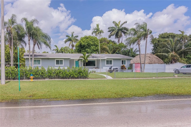 single story home featuring a front lawn