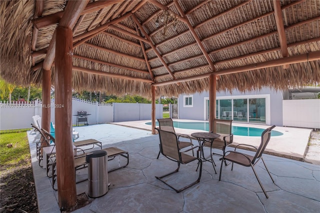 view of patio / terrace featuring a gazebo and a fenced in pool