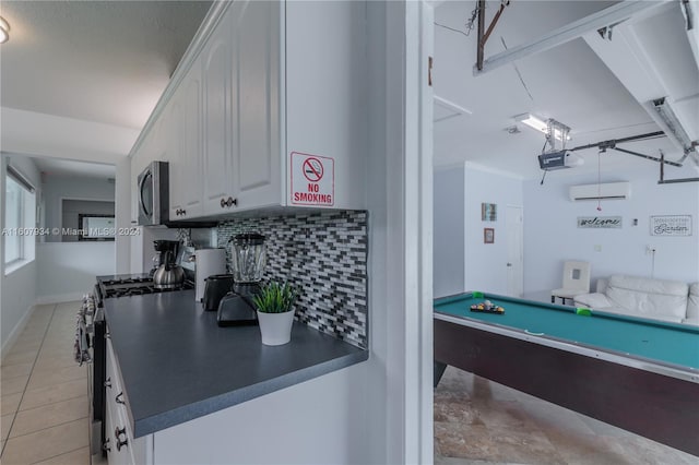 playroom with light tile flooring, pool table, and a wall mounted air conditioner