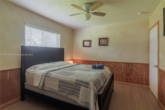 bedroom with wood-type flooring and ceiling fan