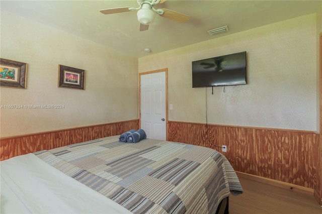 bedroom with wood-type flooring and ceiling fan