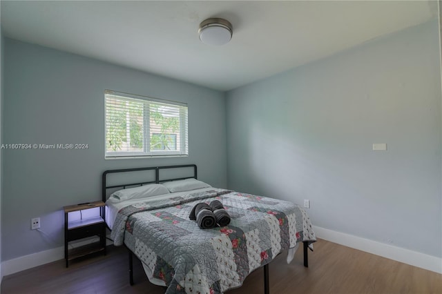 bedroom with hardwood / wood-style floors