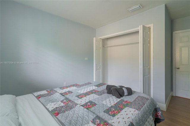 bedroom featuring hardwood / wood-style flooring and a closet