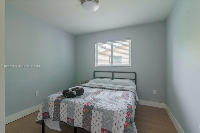 bedroom with wood-type flooring